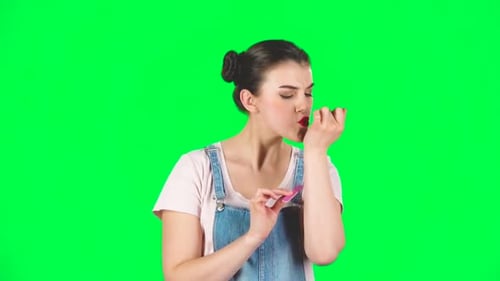 Young Woman Filing Nails Against Chroma Green Screen