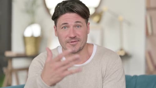 Man Talking and Gesturing at the Camera