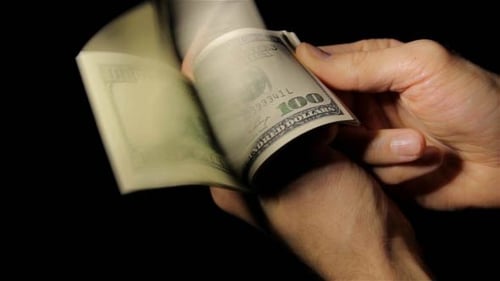 Hands Counting Stack of One Hundred Dollar Bills