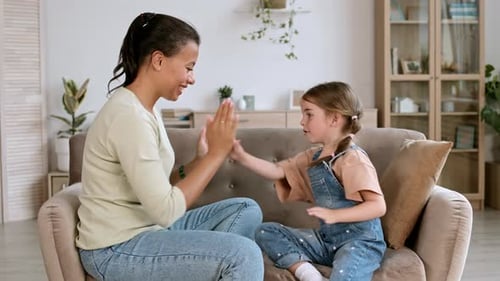 Woman Playing with Little Girl
