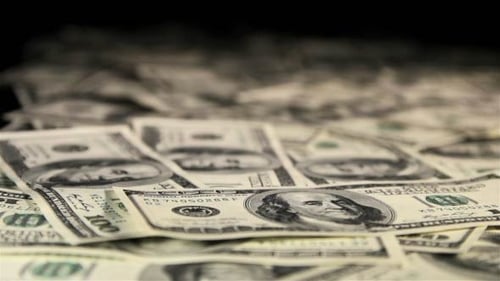 Pile of 100 Dollar Bills Coming into Focus