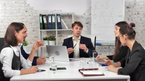 Stylish Business People Smiling and Discussing Project Together Having Team Meeting at Modern Office