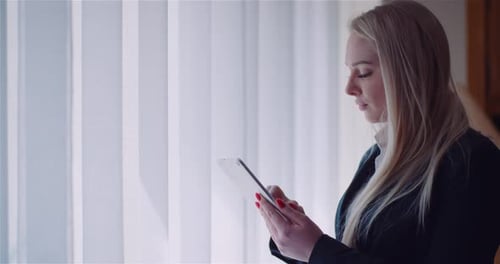 Businesswoman Using Digital Tablet at Home Office Browsing Internet Reading Emails