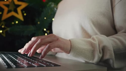 Woman Typing on Laptop During Christmas Holiday