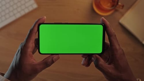 Smartphone with Green Mockup Screen in Black Male Hands