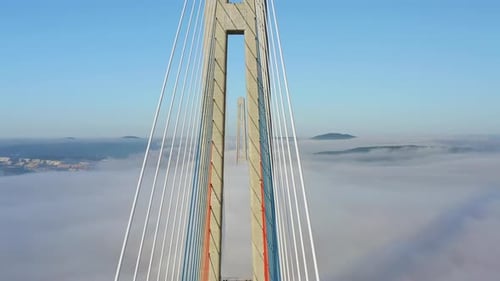 Flying Between the Cables of the Bridge Built Over the Sea Strait