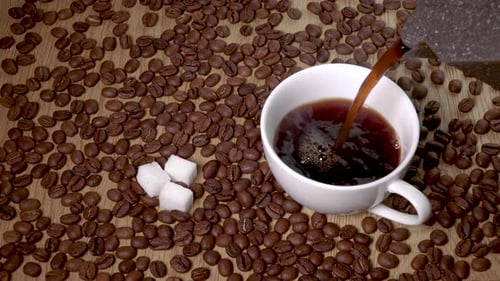 Coffee Pouring into White Mug with Sugar