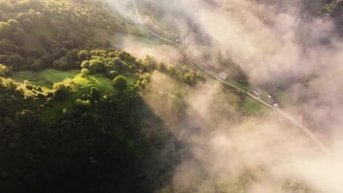 Fog Morning Over the Hill and River of the Meadow Near a Rural Village with a House Aerial View