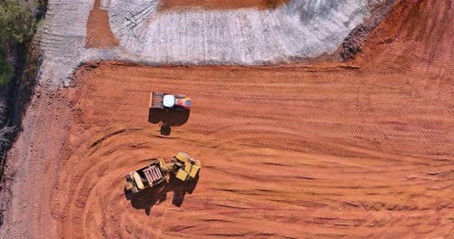 Preparation of the Land for the Construction Site with Heavy Tractor Machinery Doing Moving Soil