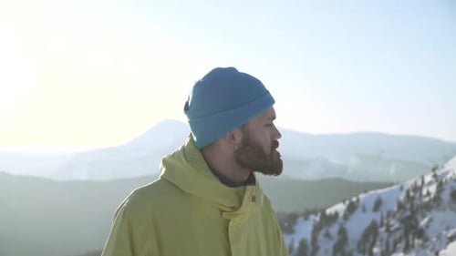 Man on Snowy Mountain Peak in Winter