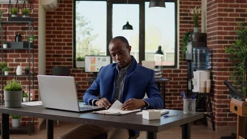Financial Analyst Looking at Business Report Documents