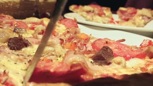 Homemade Pizza Closeup Woman Separating Slices with a Table Knife