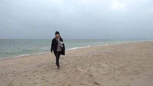 The Girl Walks on the Beach