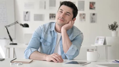 Thinking Positive Casual Young Man Brainstorming at Work