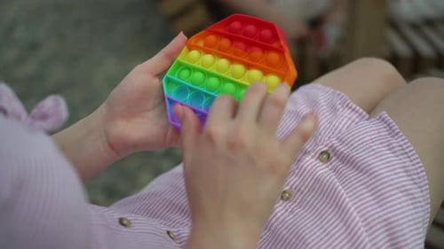 Woman Playing with Pop-It Fidget Toy