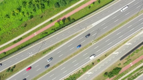 Aerial view of a freeway intersection. Clip. Highway and overpass with cars and trucks, interchange,