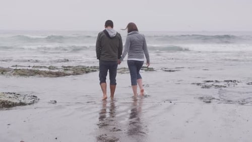 Couple walking at beach together. Shot on RED EPIC for high quality 4K, UHD, Ultra HD resolution.