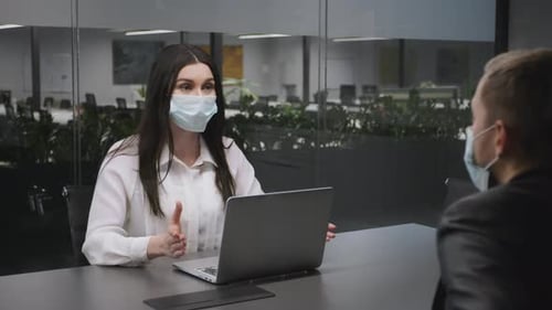 Professional Woman Discussing Business in Masked Office Meeting