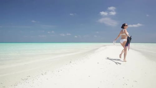 Woman Walking on Sandbar in Bikini with Flippers