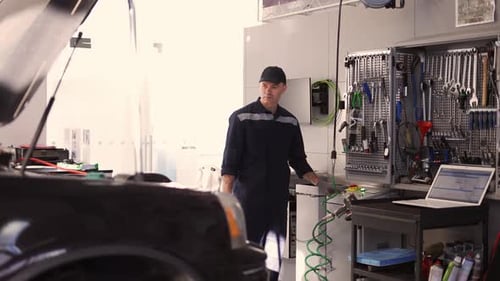Professional Car Mechanic is Lifting the Car Automatically in Car Service
