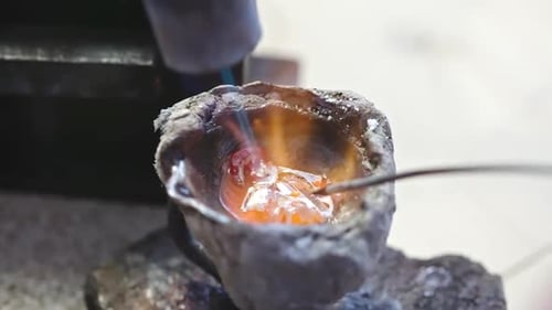 Stirring Molten Metal with Rod