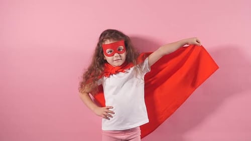 Smiling Child Poses in Hero Costume, Red Cape