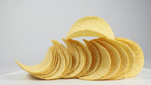 Stacked Potato Chips Arranged on White Surface
