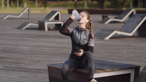 Sportswoman Resting in Park