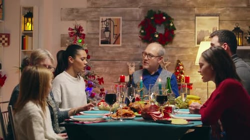 Family Celebrates Holiday Meal at Decorated Table
