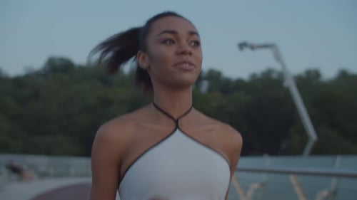 Woman Jogging for Fitness on City Bridge