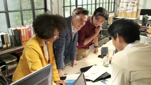 The coworker's team and colleagues brainstormed, discussing in the workplace.