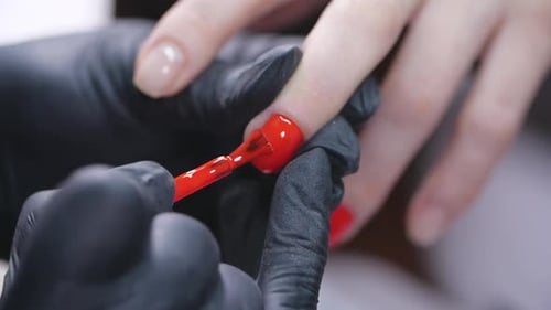 Applying Red Nail Polish in Close Up Detail