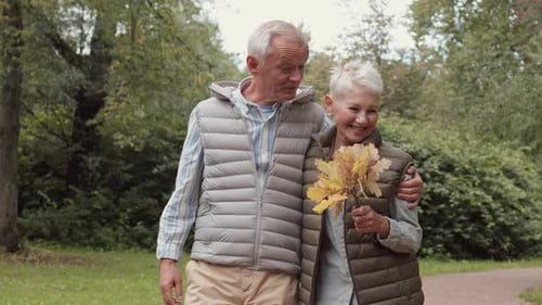 Couple Walking in Autumn Park
