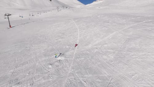 Two Males Riding Ski and Snowboard From Mountains Slope in Slowmotion