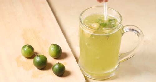 Refreshing Lime Beverage with Fresh Fruit and Straw