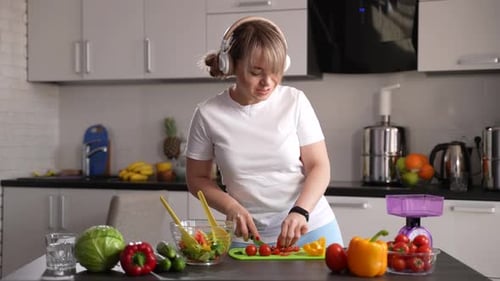 Woman Happily Prepares a Healthy Vegetable Salad