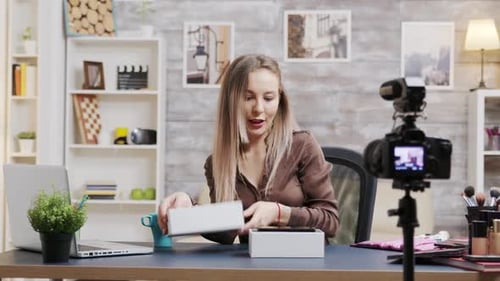 Woman Unboxing New Cellphone While Filming Video