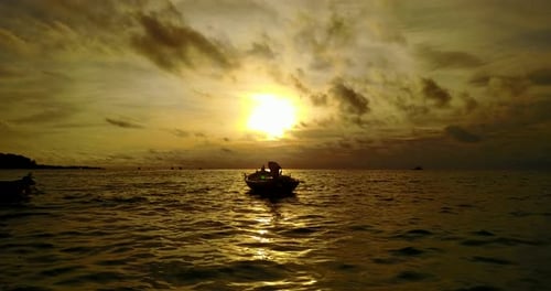 Wide drone island view of a white sandy paradise beach and aqua turquoise water background in vibrant