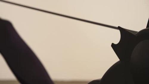 Person Exercising on Rowing Machine in Home