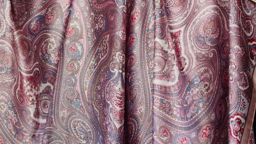 Flowing Fabric with Pink Paisley Pattern Close-Up