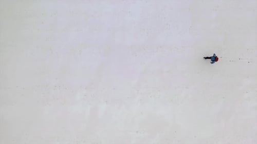 Lonely Human Walk By Snow Desert, Aerial Footage