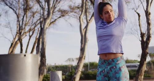 Caucasian woman stretching in a park