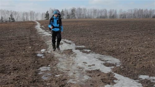 Man Hiking with Backpack in Rural Setting