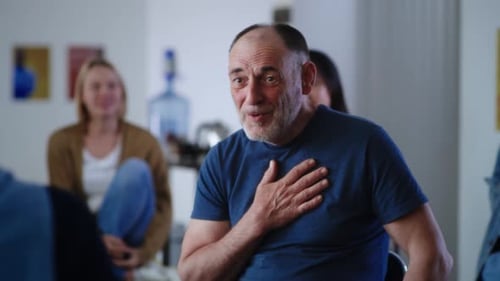 Man Celebrates Achievement in Support Group Session