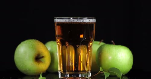 Rotating Fresh Apple Juice in the Glass.