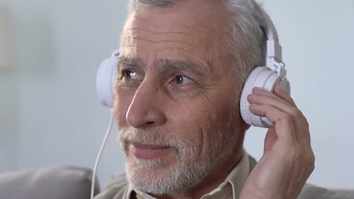 Senior Man Enjoying Music with Headphones Close-Up