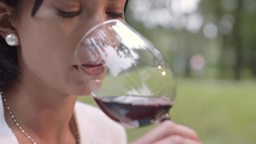Beautiful Woman Drinking Wine Outdoors