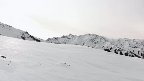 Snowy Mountain Range Landscape Underneath a Cloudy Sky
