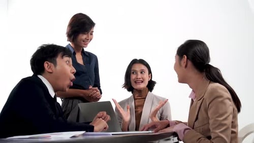 Happy Business Team Celebrates at Table