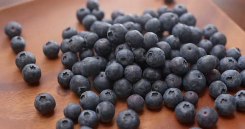 Fresh Blueberries Piled on Wooden Board